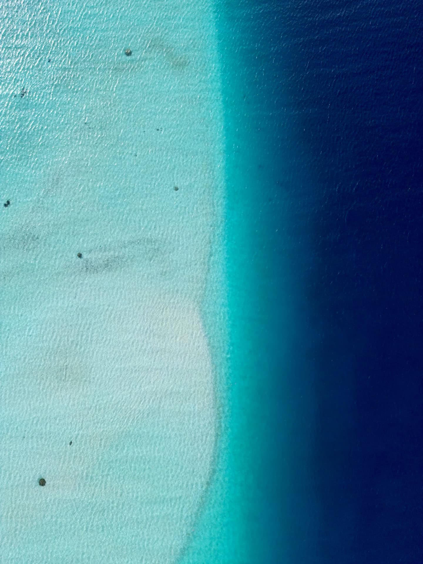 Shades of blue of a Polynesian lagoon seen from above