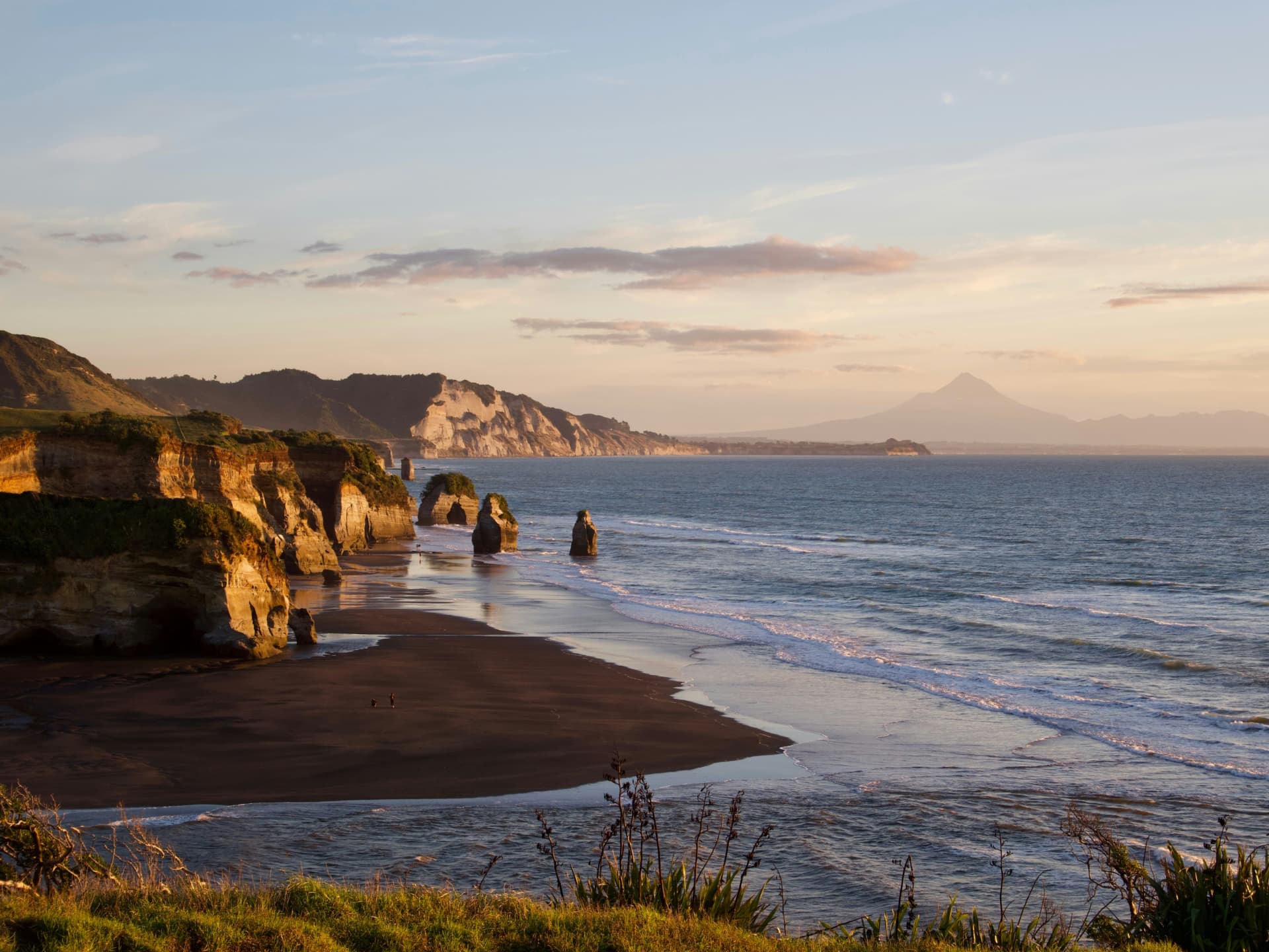 Wild New Zealand coastline at sunset — closing image