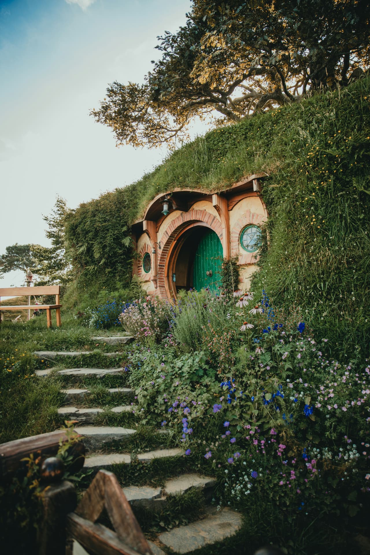 Flower-framed hobbit house in the North Island hills