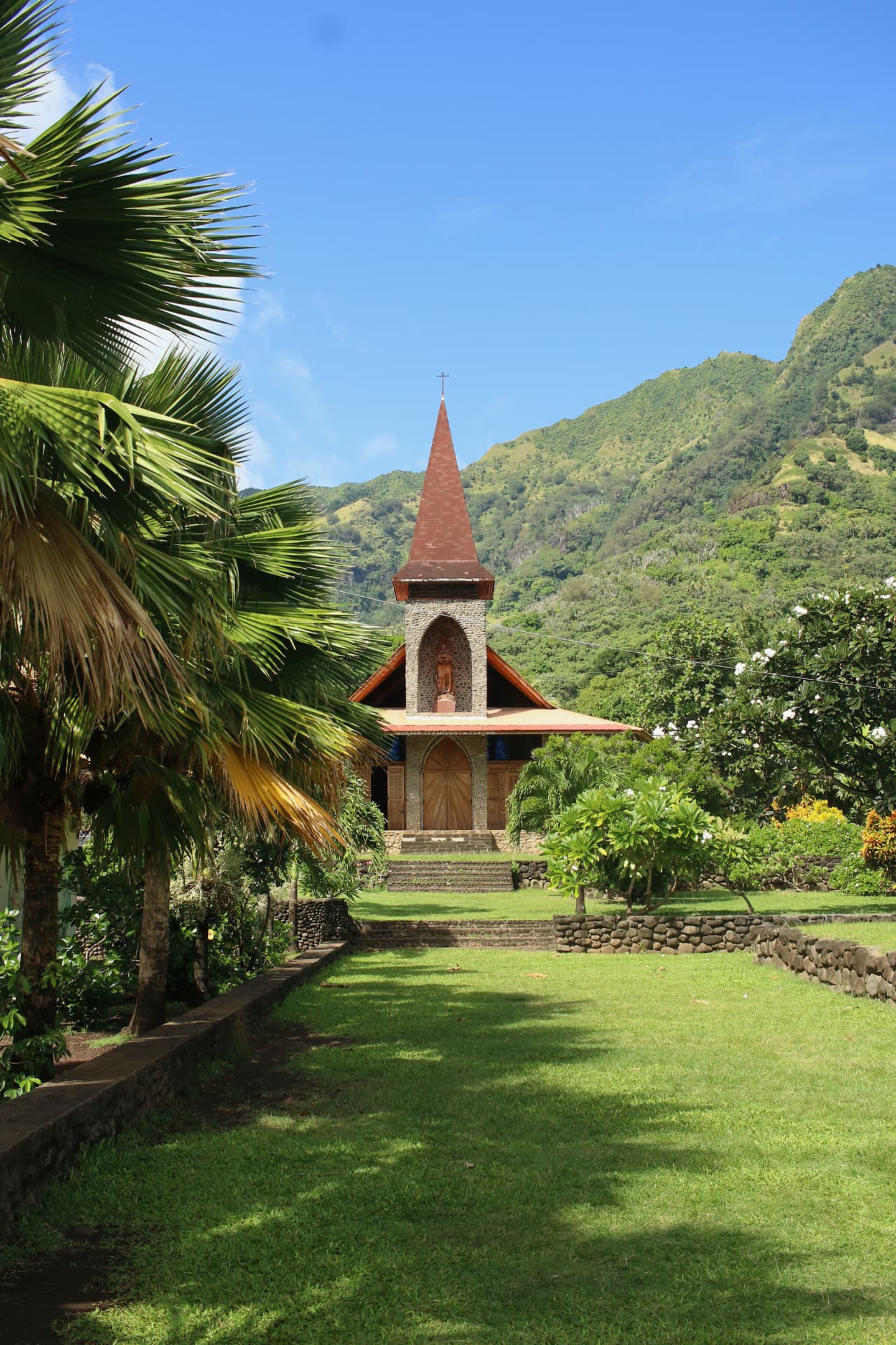 Stone and timber church at the foot of the mountains, Marquesas Islands